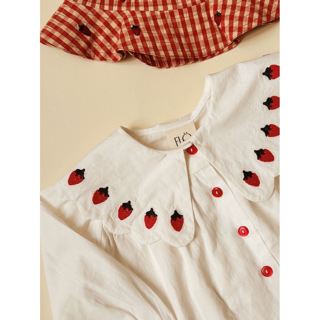 Close-up of the strawberry-embroidered collar on Flöss Everlyn blouse