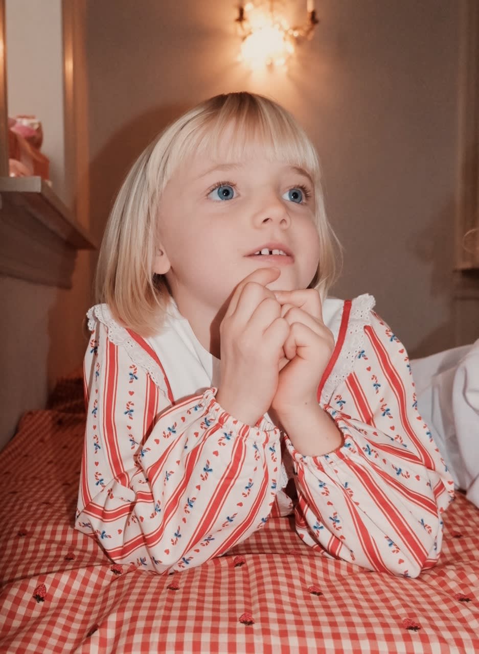 Close-up of Flöss Noelle Holiday Stripe dress showing its embroidered white yoke