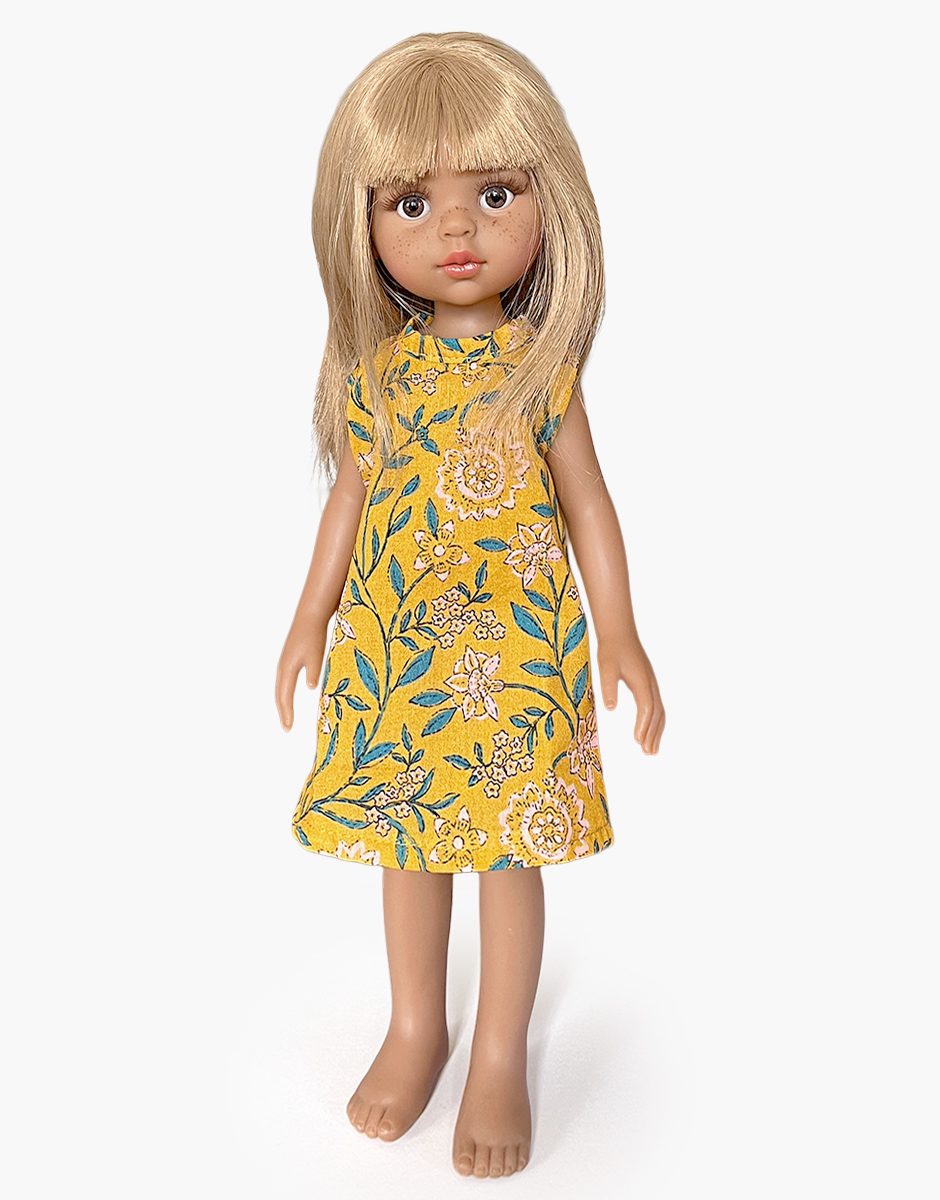 Minikane Adèle Amigas doll wearing a mustard vine floral Iva dress