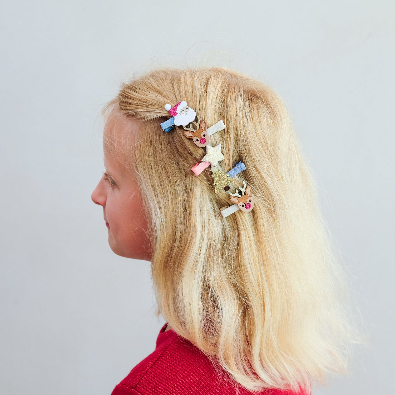 Child wearing Mimi &amp; Lula Christmas salon hair clips