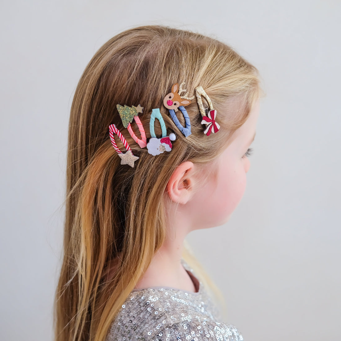 Child wearing Mimi &amp; Lula Christmas mini hair clips