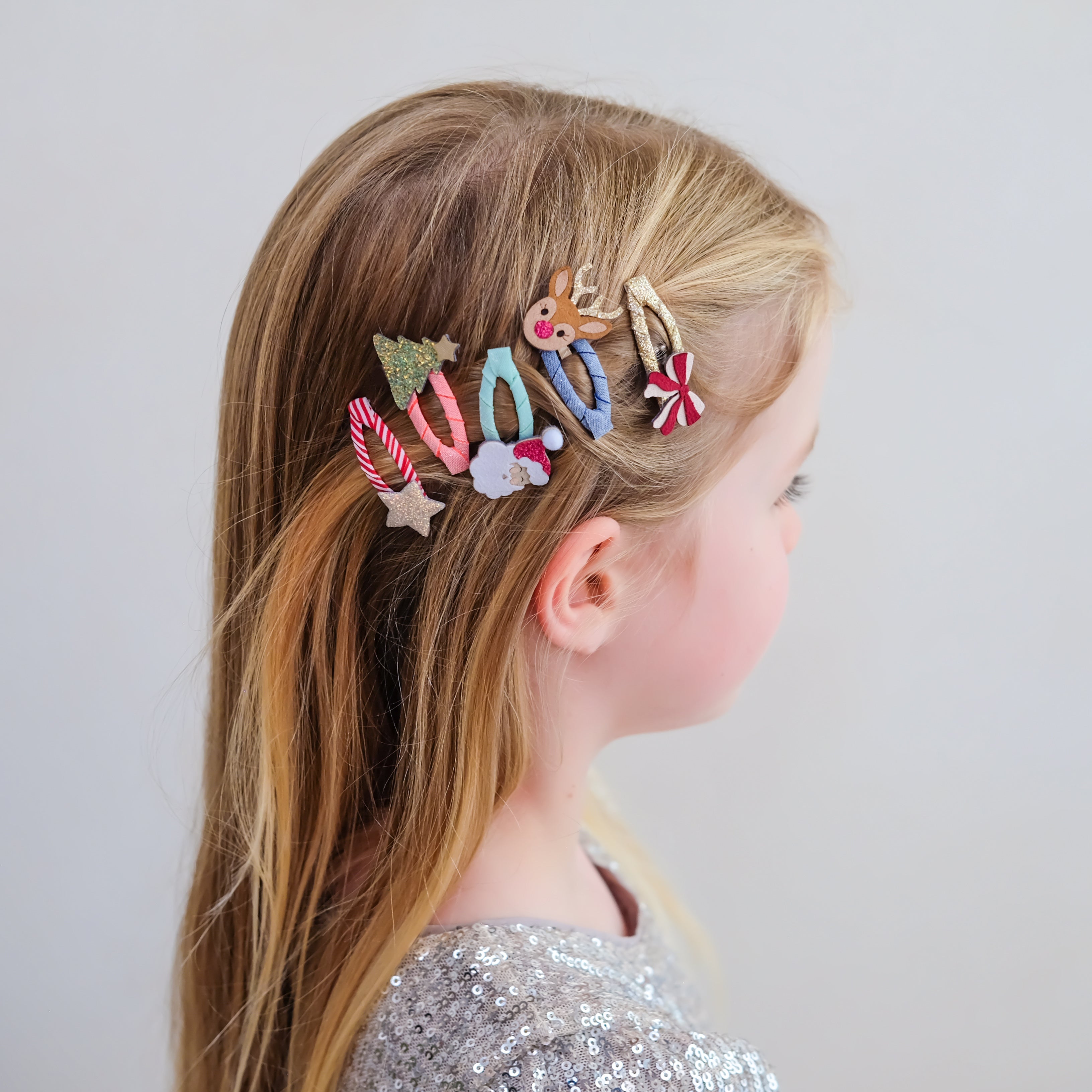 Child wearing Mimi &amp; Lula Christmas mini hair clips