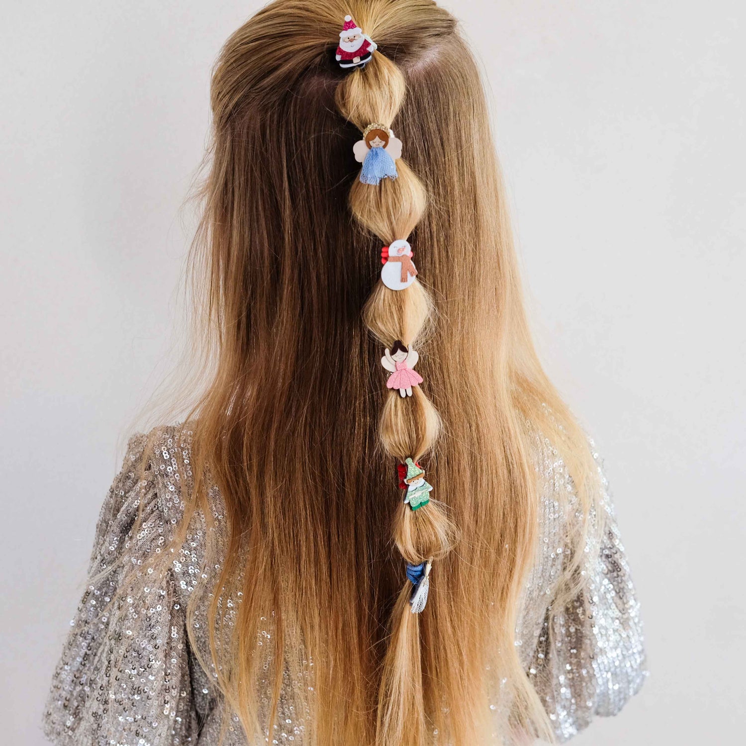 Christmas character hair ties styled in a braid