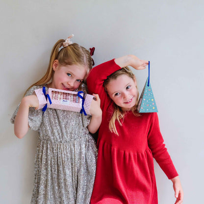 Child holding Mimi &amp; Lula scrunchie Christmas cracker