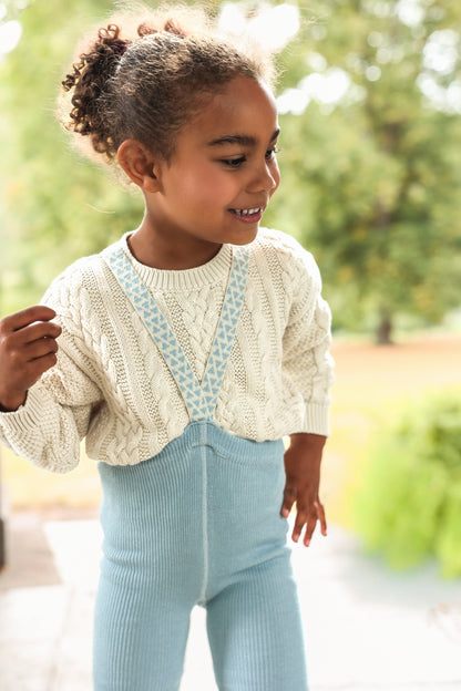 Silly Silas Child wearing Misty Blue footless tights with a cream sweater