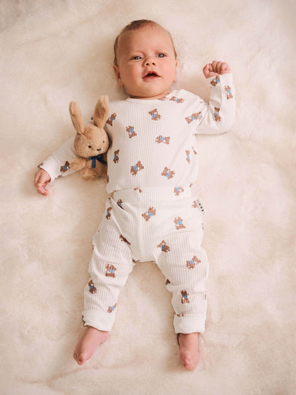 Huxbaby Tumbling Bow Hux long sleeve bodysuit in Almond Milk, lifestyle view