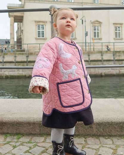 Sissel Edelbo front of the Cameo Pink jacket worn outdoors