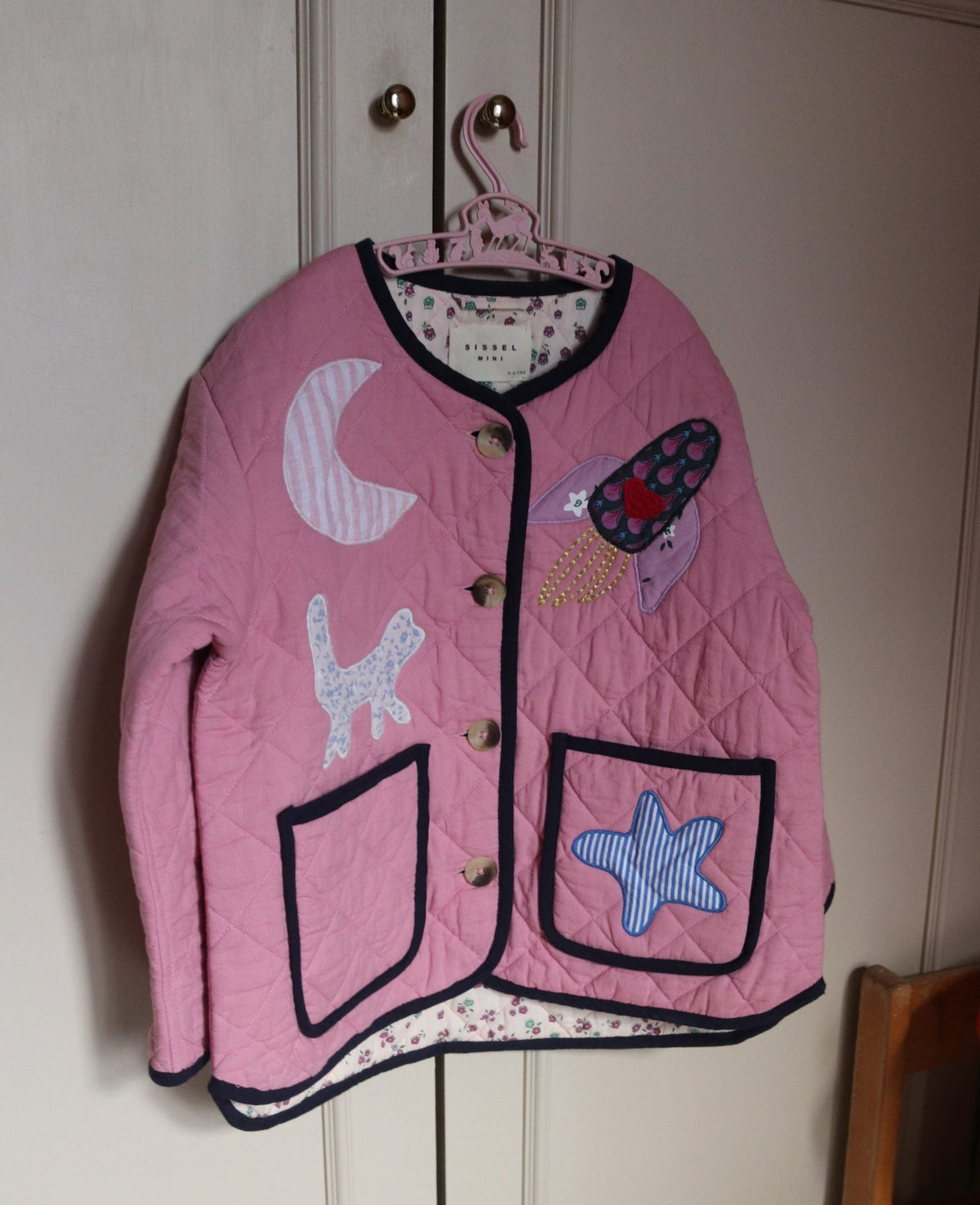 Sissel Edelbo Cameo Pink jacket hanging to show the appliqués