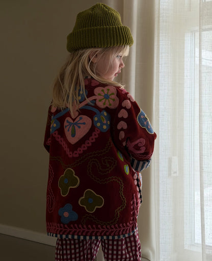 Sissel Edelbo back of the burgundy jacket worn indoors