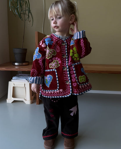 Sissel Edelbo Velvet Burgundy jacket worn with dark trousers
