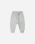 Light gray baby pants with floral patterns on a white background
