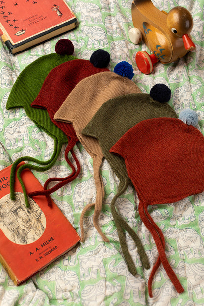 Rosie Sugden Rust cashmere baby bonnet lifestyle image