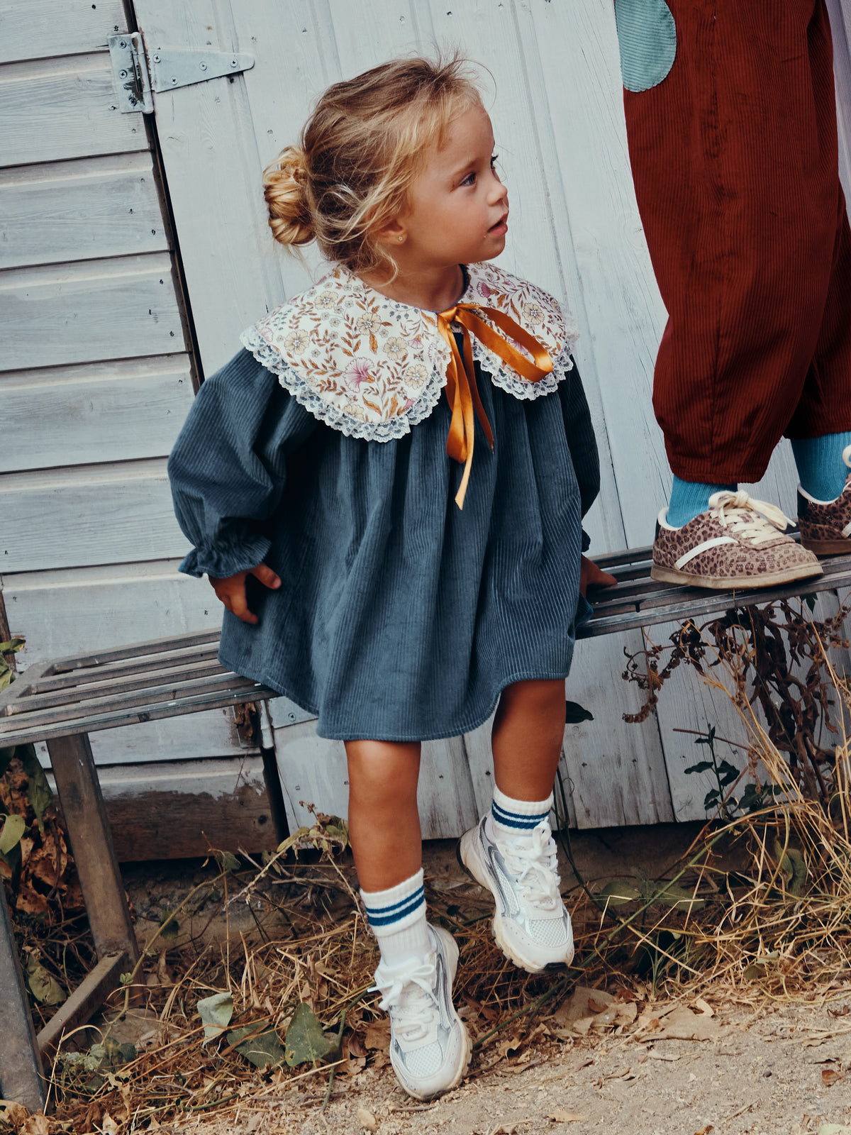Carlota Suip Midnight Waltz dress with floral lace collar and ochre ribbon