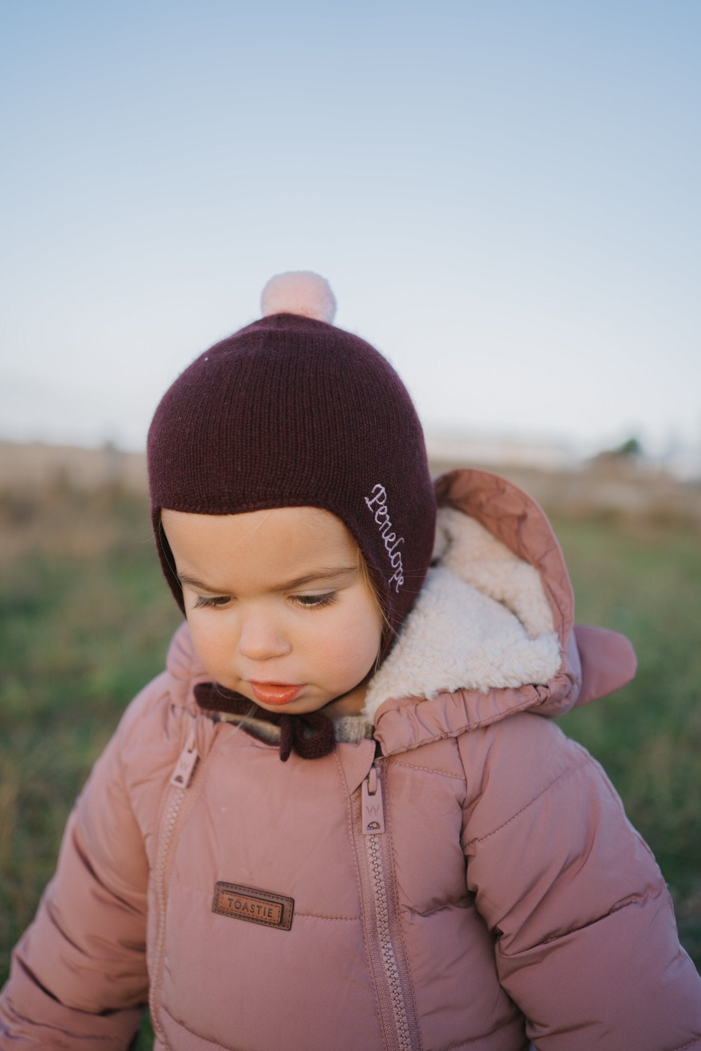 Cashmere Baby Bonnet, Kirsch with Marshmallow Pom - Pom Rosie Sugden