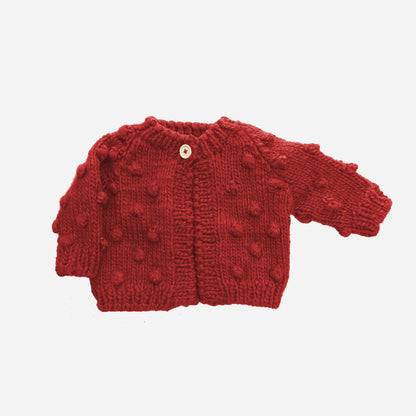 The Blueberry Hill Red Popcorn Cardigan with raised knit texture and one button