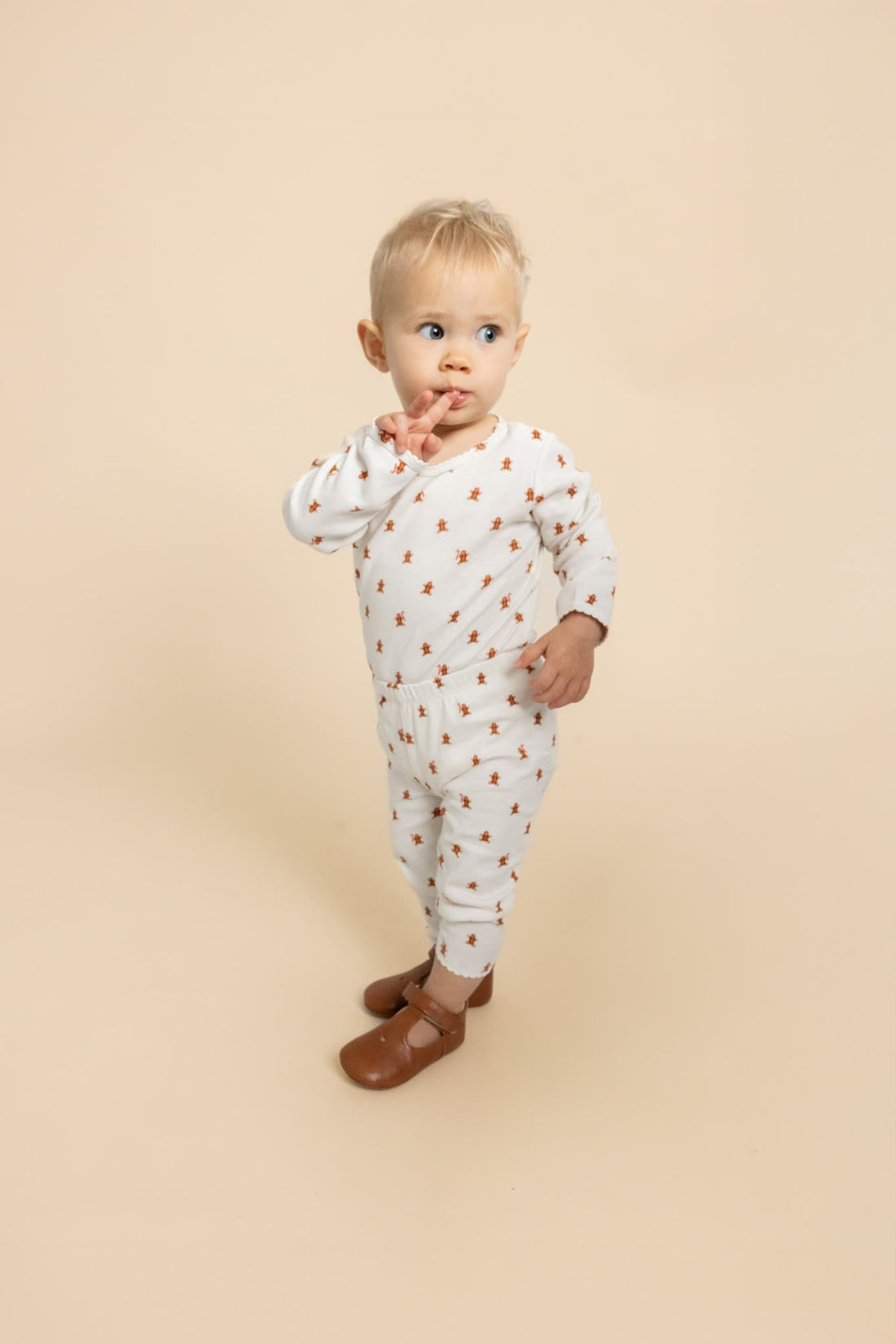 Flöss Charlie baby bodysuit in Gingerbread Dot shown on a child