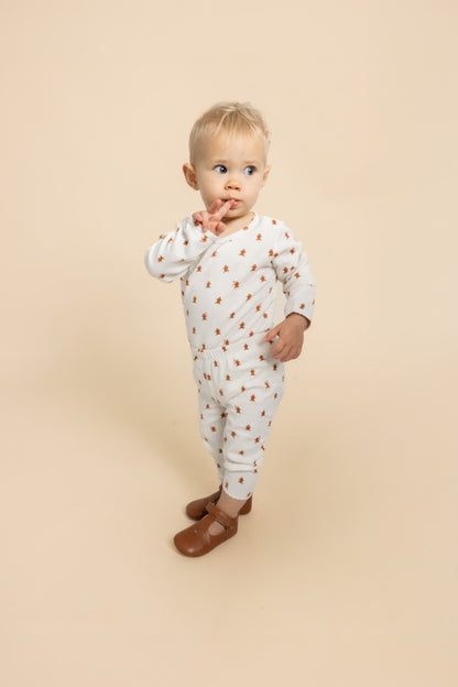 Flöss Charlie baby bodysuit in Gingerbread Dot shown on a child