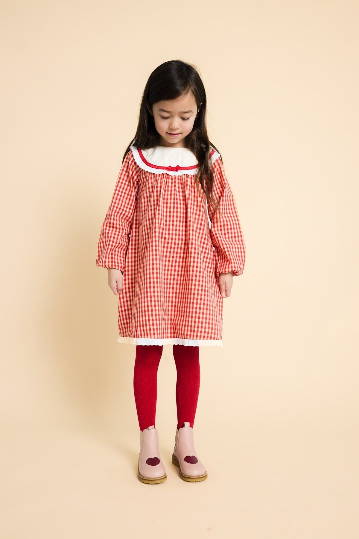 Flöss Lucia Poppy Red Gingham dress worn with red tights