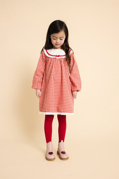Flöss Lucia Poppy Red Gingham dress worn with red tights