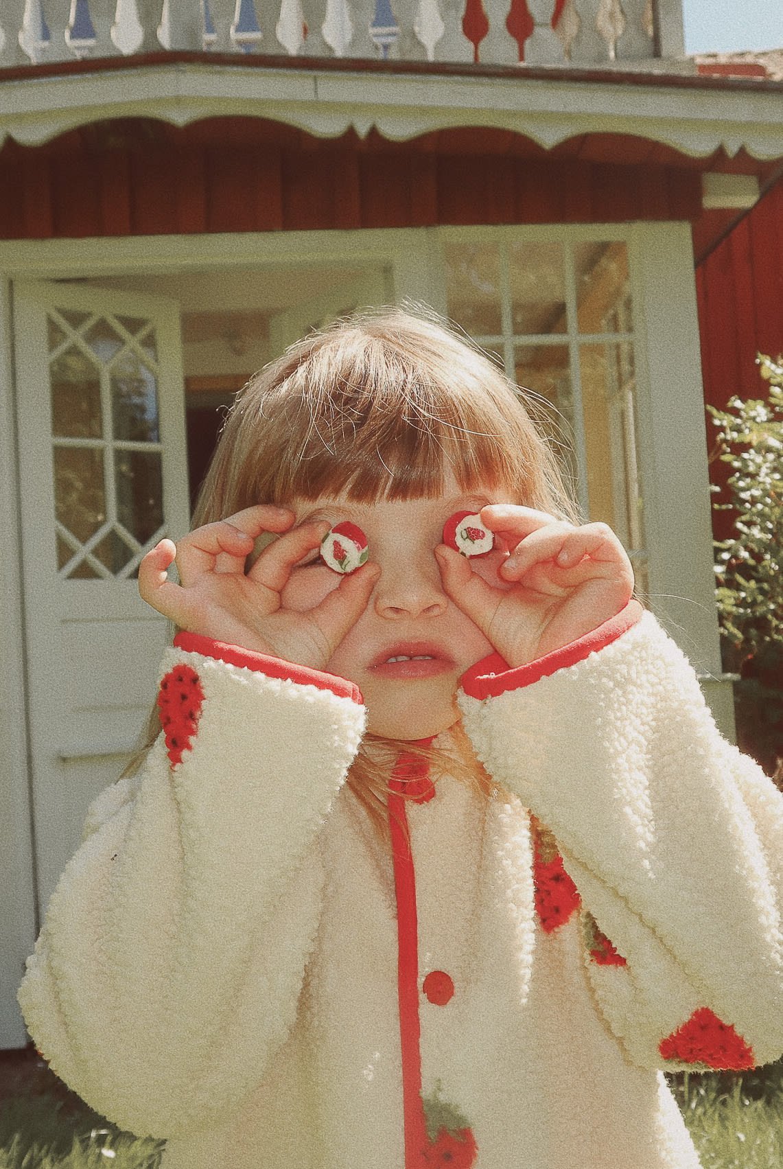 Flöss Strawberry Fleece Jacket in Soft White Berry shown outdoors