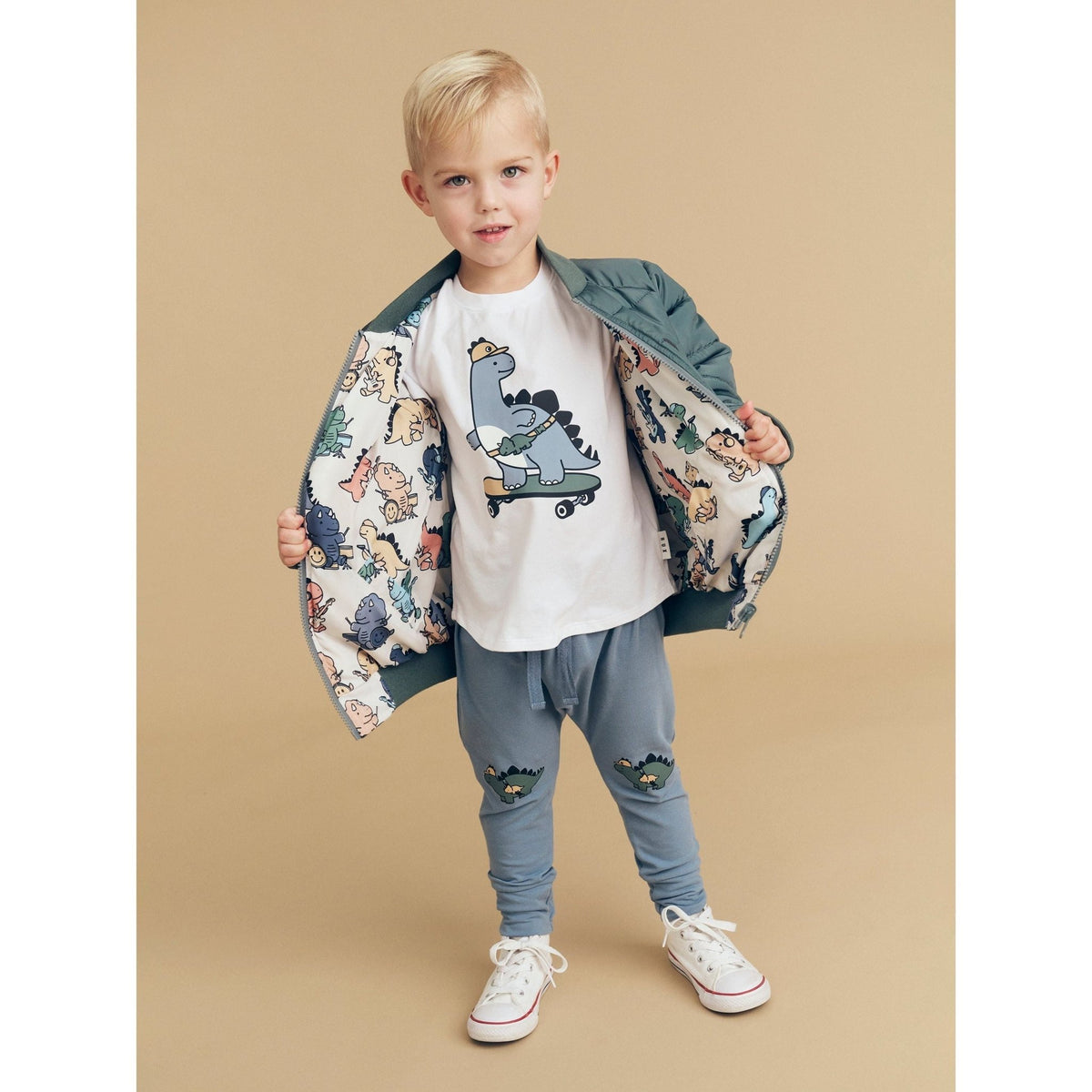 Huxbaby Adventure Dino pants in Dino Blue, styled with a printed jacket