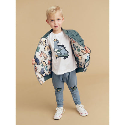 Huxbaby Adventure Dino pants in Dino Blue, styled with a printed jacket