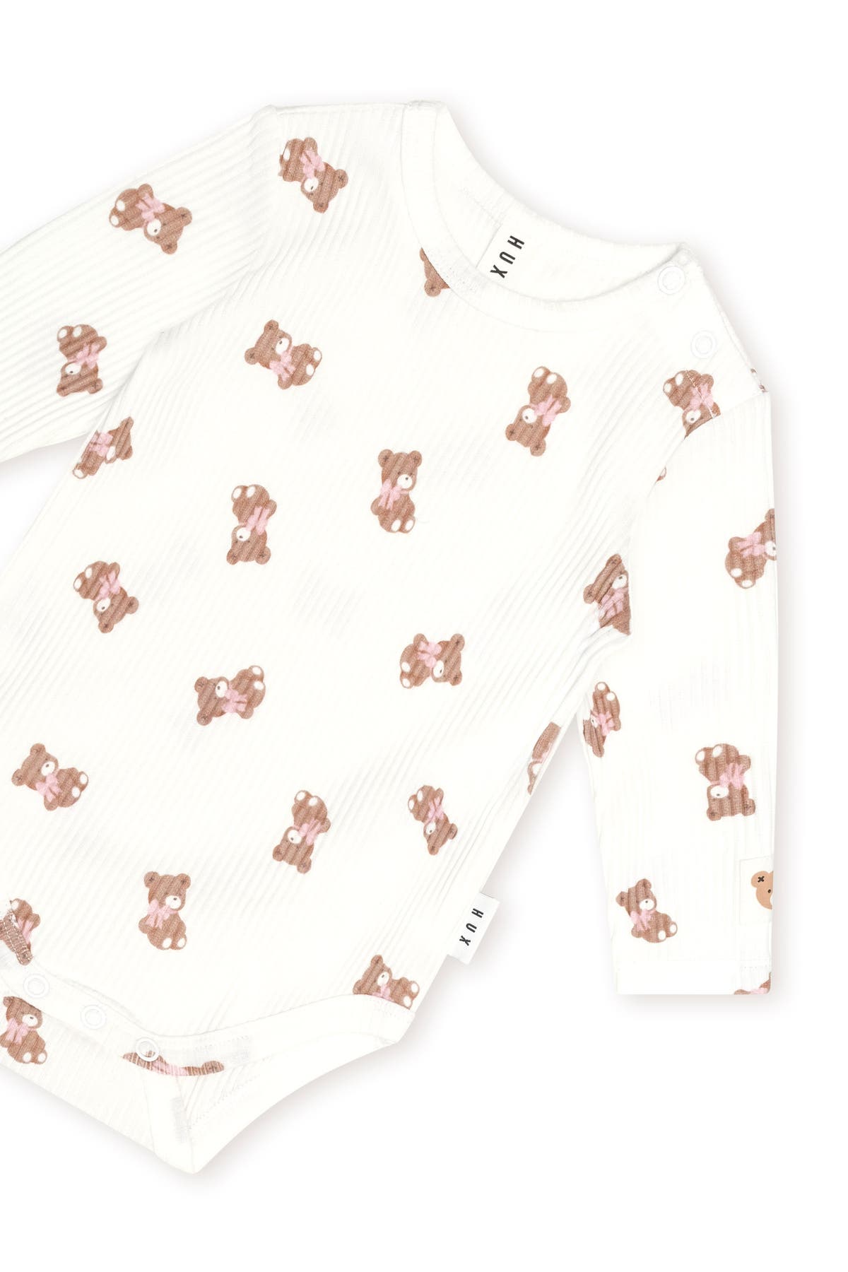 Huxbaby Tumbling Bow Huxette Long Sleeve Bodysuit in Almond Milk, detail view