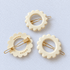 Kanel Daisy Hair Clip – Ivory Inde on a unified pale grey-white fabric background