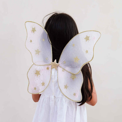 Child wearing Mimi &amp; Lula pink starry night fairy wings from the back