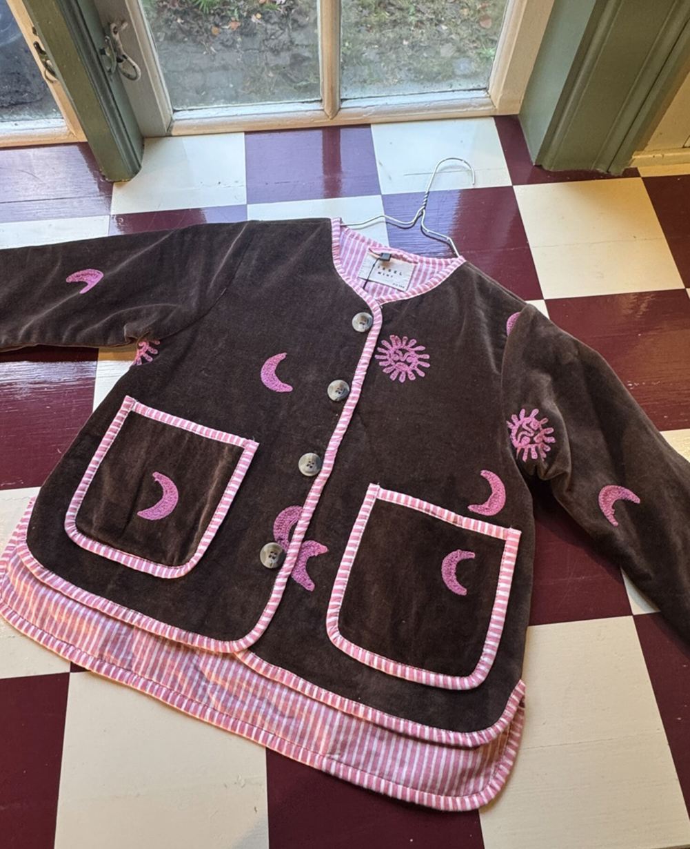 Sissel Edelbo front of the Sun &amp; Moon jacket laid flat