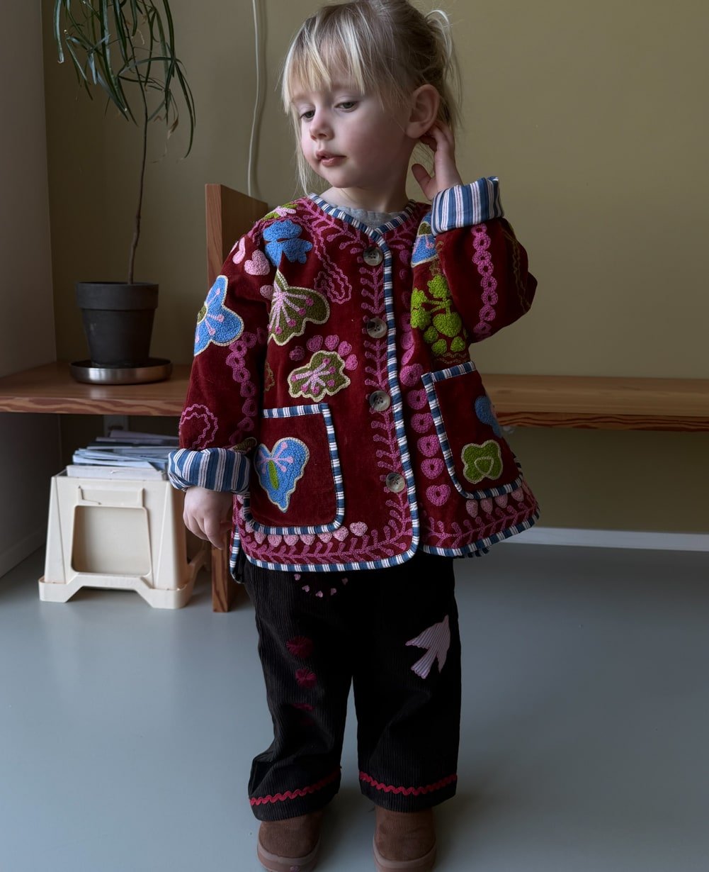 Sissel Edelbo Velvet Burgundy jacket worn with dark trousers