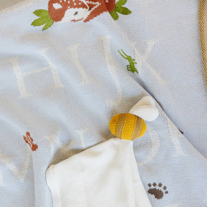 Baby playing on The Blueberry Hill ABC Woodland organic baby blanket
