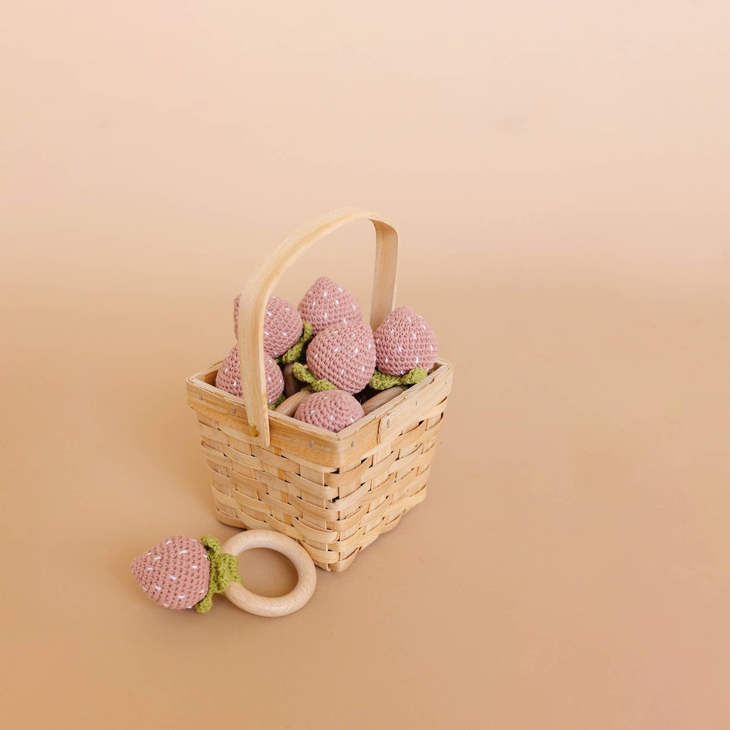Wicker basket with The Blueberry Hill strawberry crochet baby teethers
